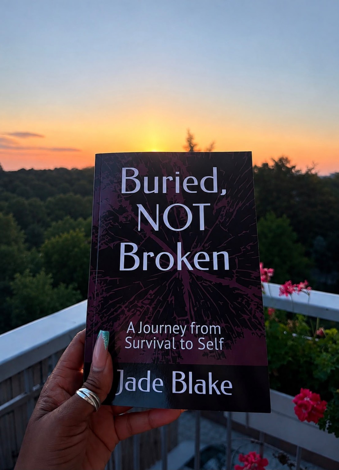 Buried, Not Broken by Jade Blake held against a sunset
